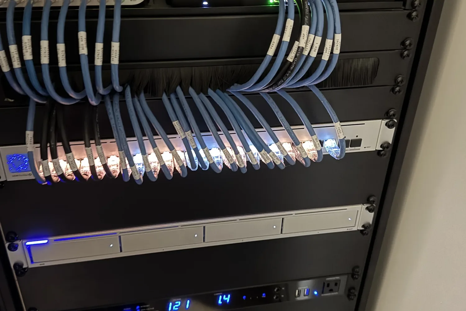 Firebird AV equipment rack at night, network cabling dressed in even service loops