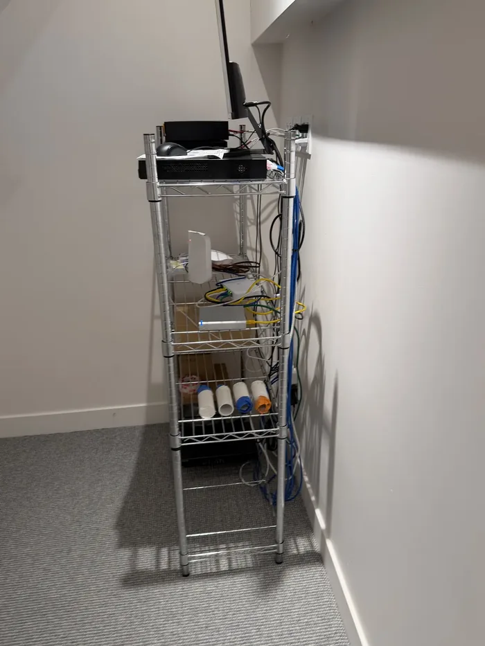 Temporary wire shelving holding loose equipment and undressed cable