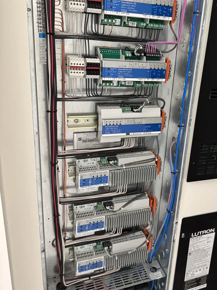 Finished Lutron HomeWorks lighting panel with conductors laced in parallel runs over a copper ground bus