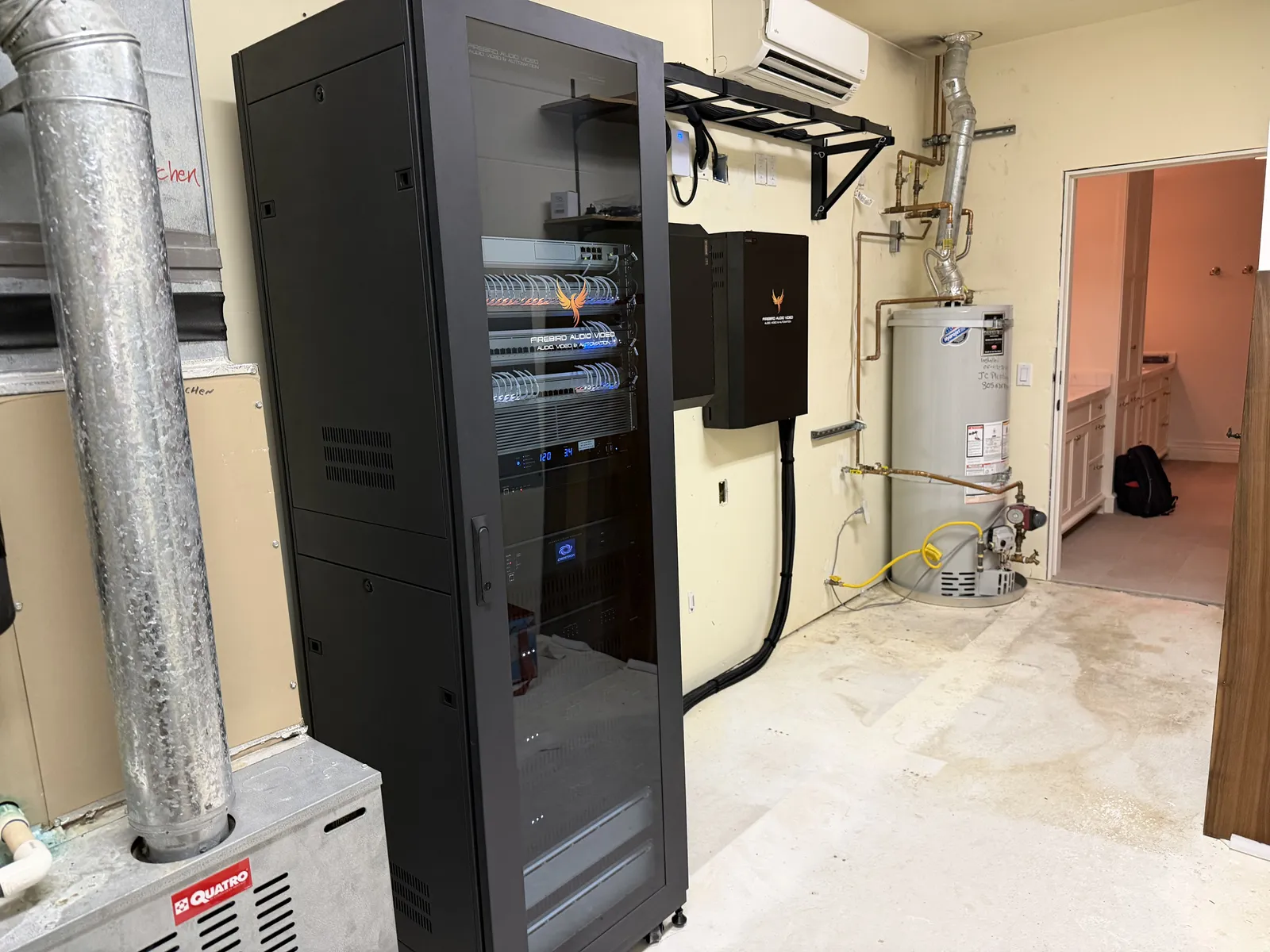 Finished plant room after the Firebird AV system takeover — rack, distribution, and power as one wall