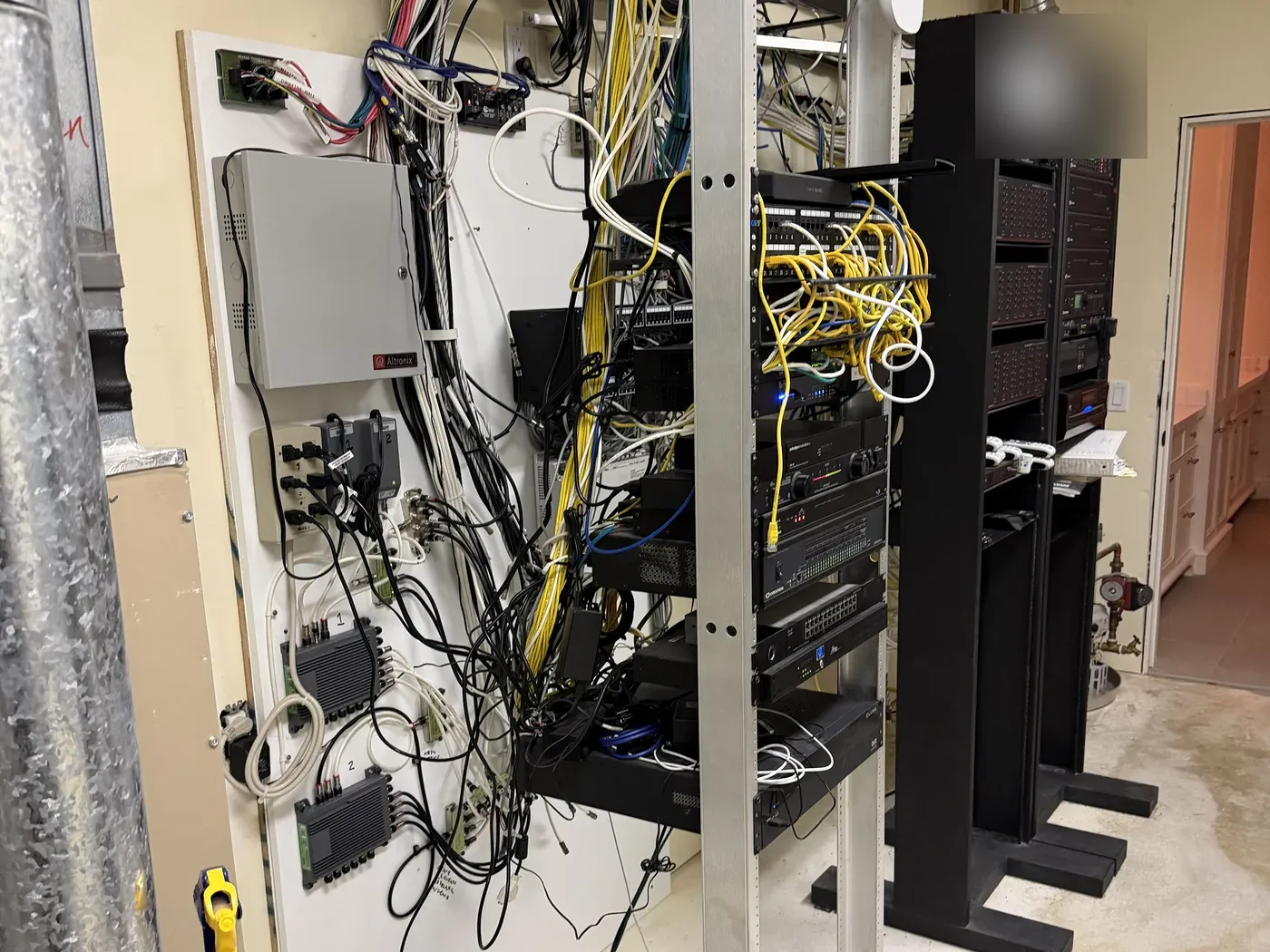 Cluttered legacy AV racks and wiring before Firebird's Santa Ynez estate takeover